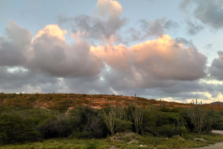 The sun casting a golden hue over the hills behind Spanish Lagoon